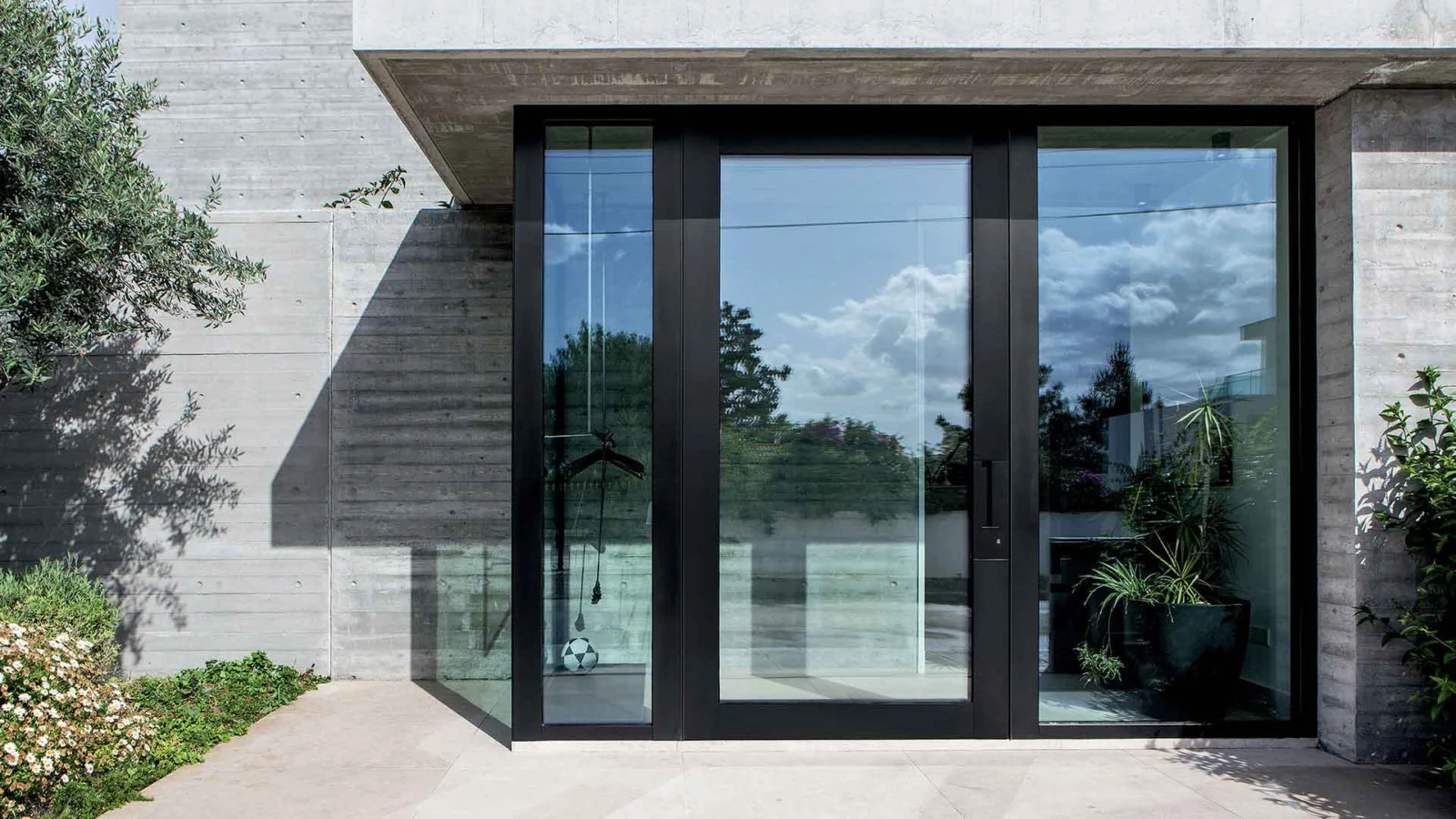 Oikos Nova glazed entrance with dark aluminium framing.