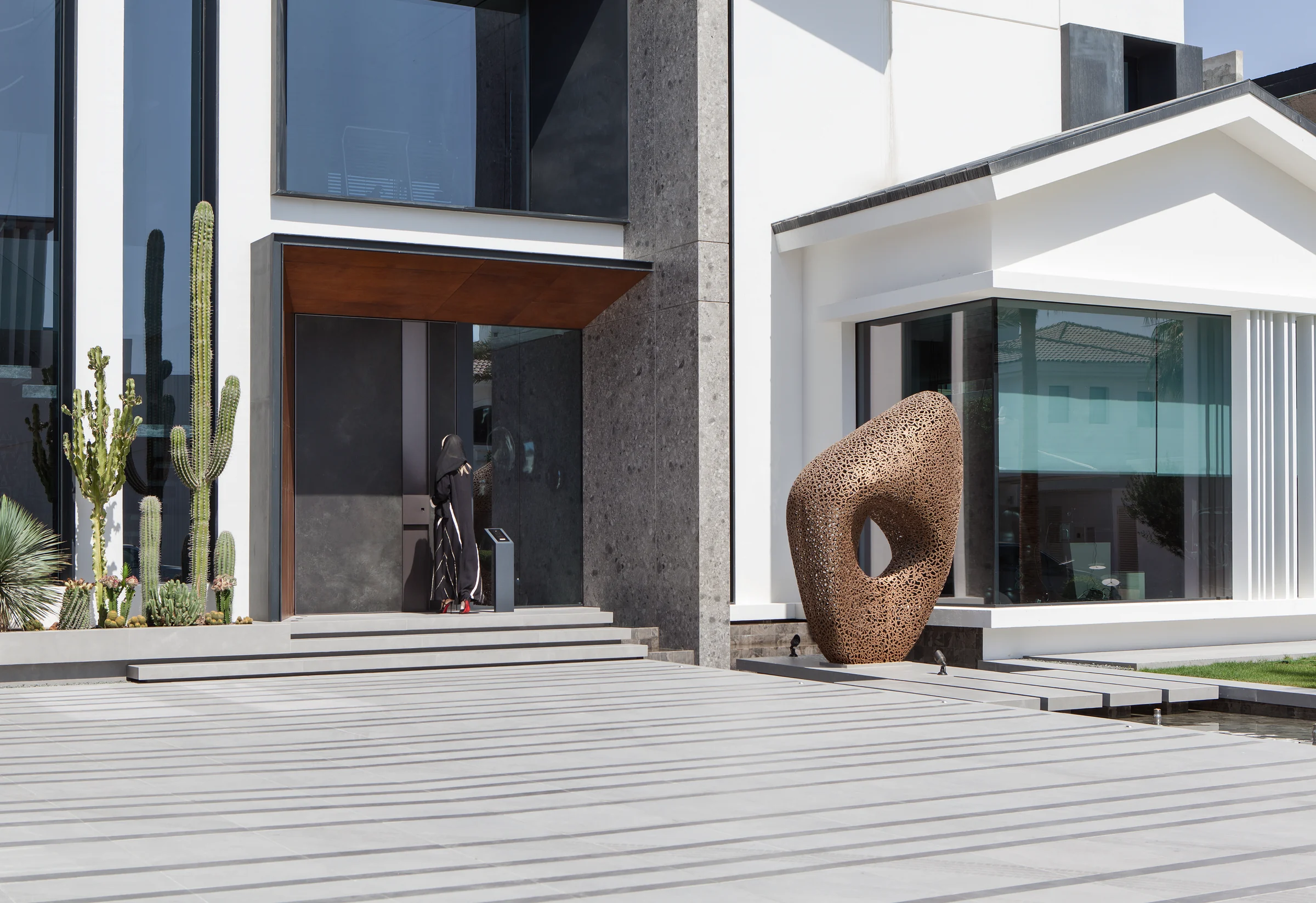 Villa 11 in Dubai: sculptural entrance framed by stone and timber.