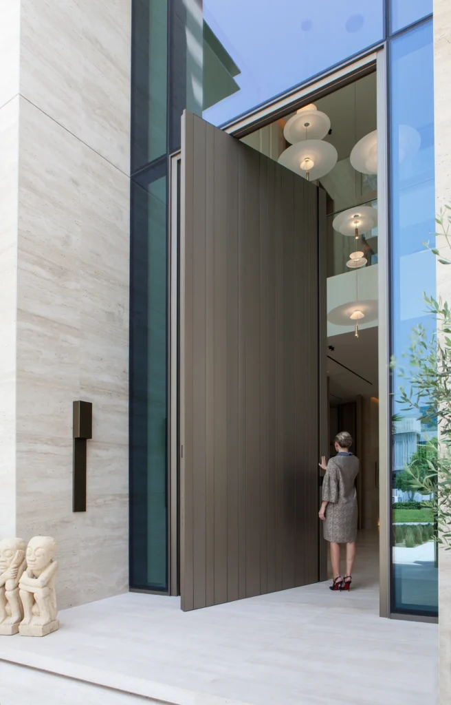 Villa 12 in Dubai: open entrance door and full-height glazing.