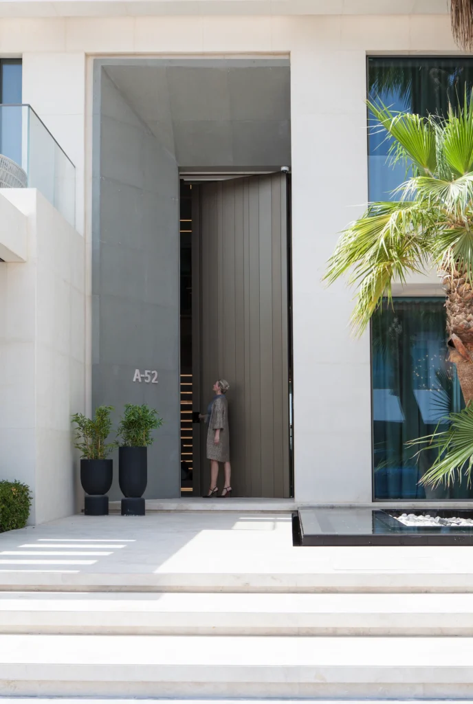 Villa 13 in Dubai: full-height entrance within the stone facade.